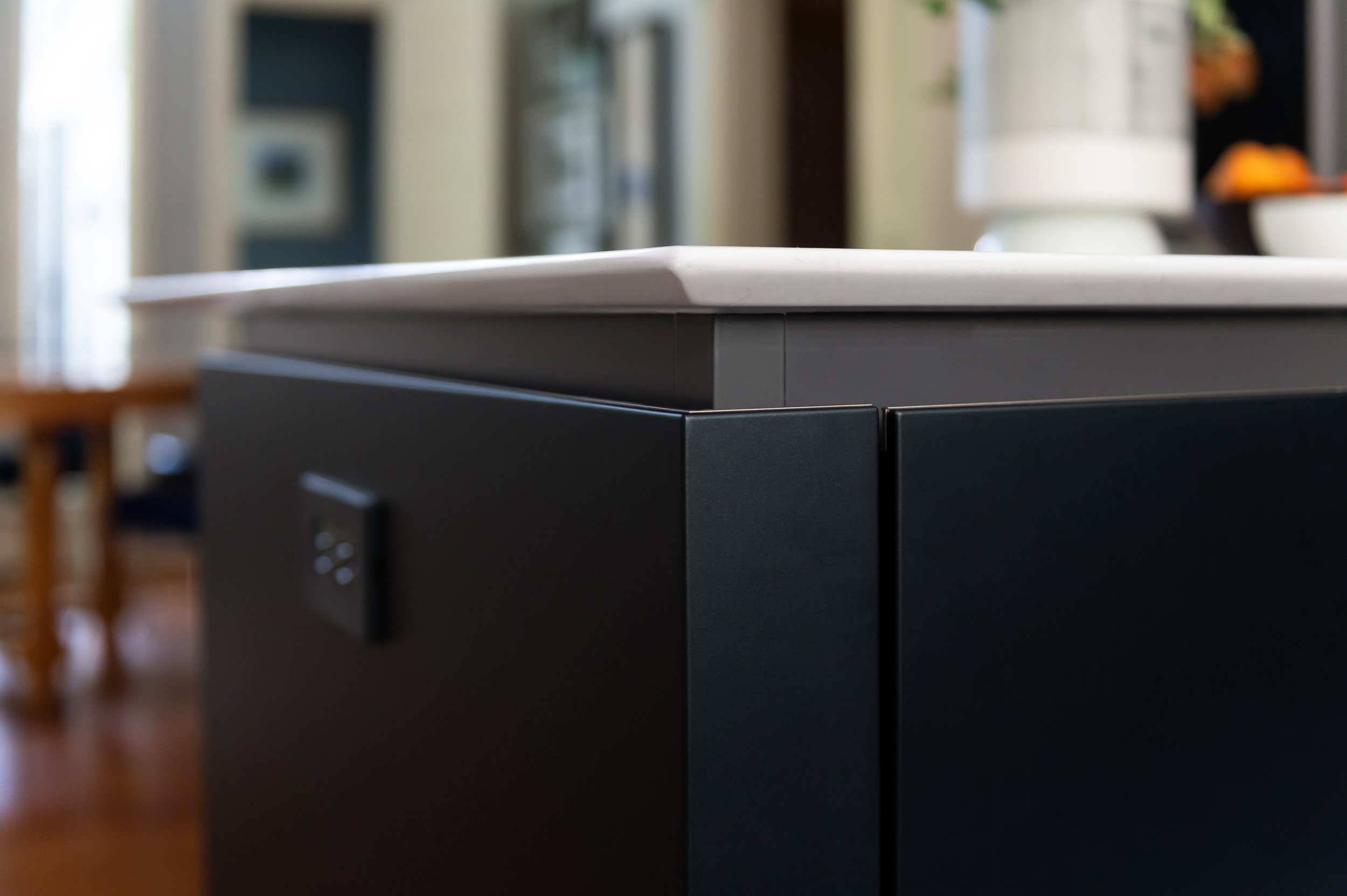 Close detail of dark cabinetry and counter edge